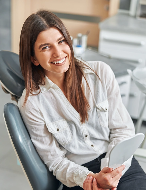 Woman smiling Laying On Dentist Chair