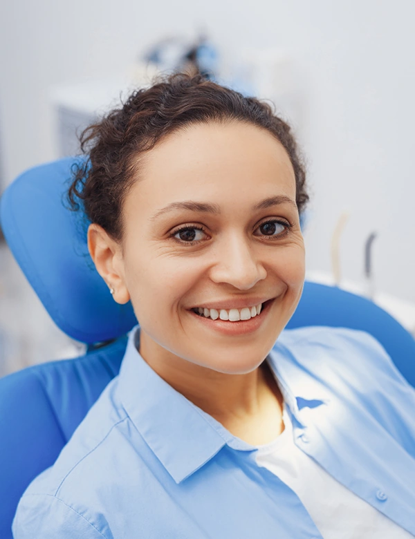 Woman smiling Laying On Dentist Chair