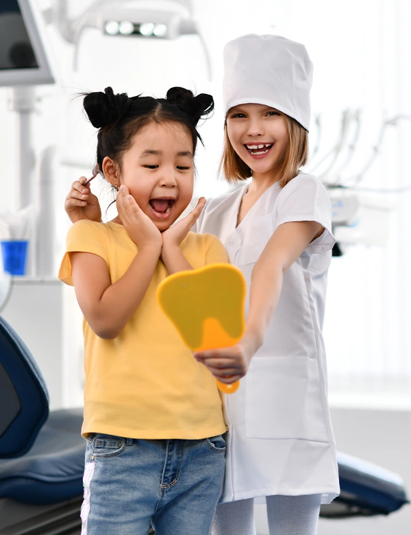 Children Smiling Staring at The Mirror